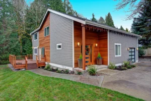 Modern house with wooden deck and driveway.